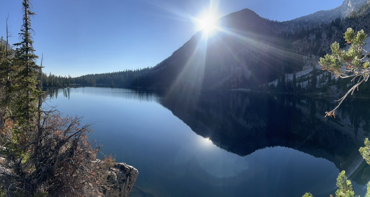Mountain lake at sunrise, the water perfectly still