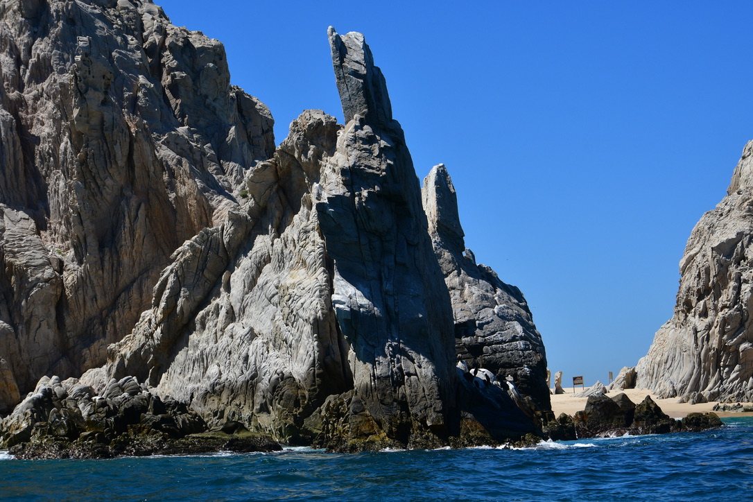Tall granite sea stacks rising from deep blue water